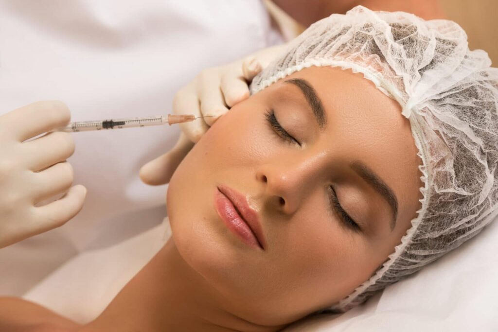 Woman in professional beauty salon during facial injections for rejuvenation